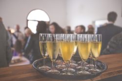 a tray of glasses filled with champagne during a party