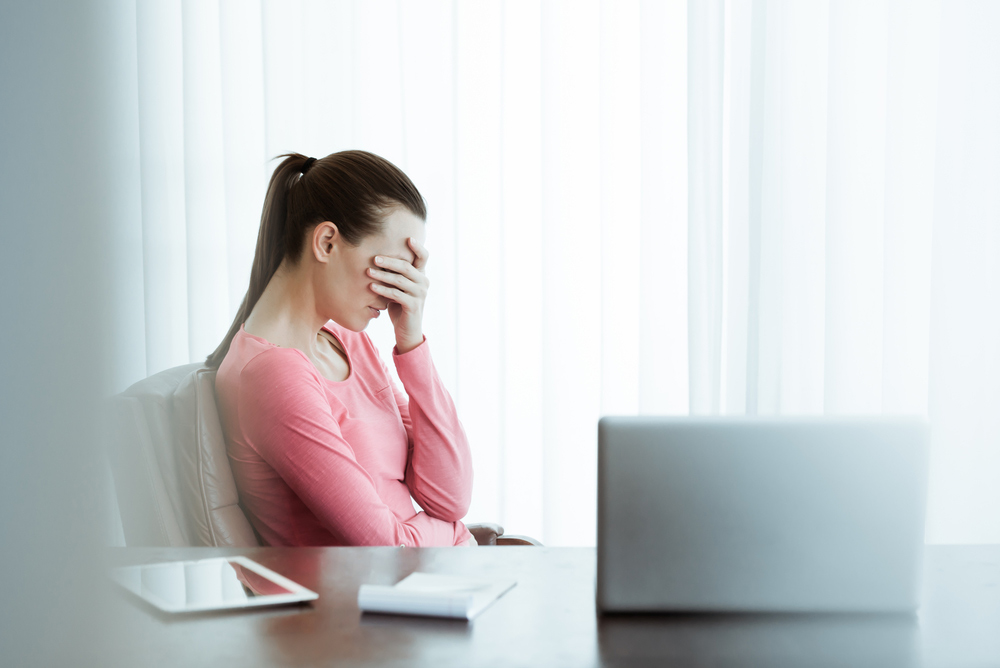 lighthouse-treatment-center-xanax-addiction-woman-stressed-out-in-office