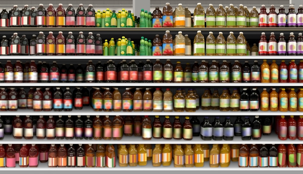 Supermarket shelves with bottles of kombucha and other beverages 