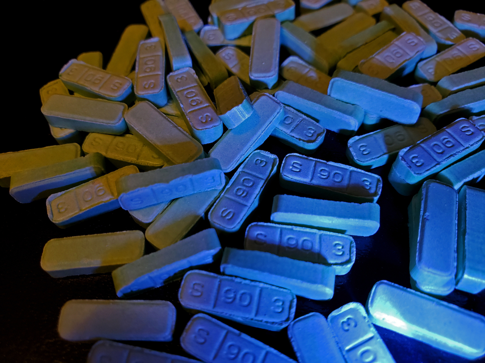 Blue Xanax bars B707 pills on a black surface