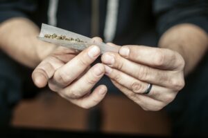 Man rolling a weed marijuana joint