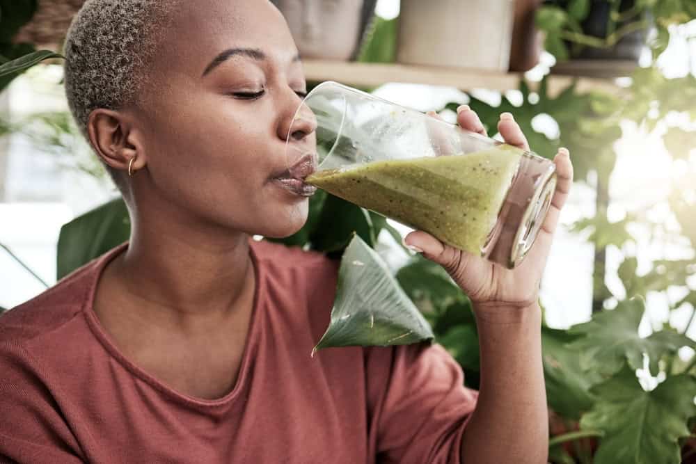 Woman drinking vegetable smoothie