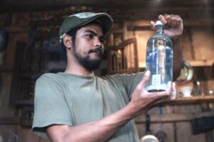 Man looking at an old bottle of vodka