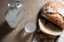 Shots of vodka with bread beside it