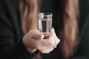 Shot of gluten-free vodka being held by a person