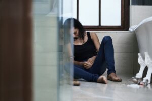 Woman seated in the bathroom high on ketamine drug
