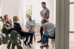 Man working as a peer support staff at a recovery center for drugs and alcohol addiction