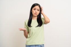 Woman in green shirt questioning if she can rebuild life after addiction