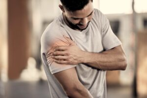 Man in gray shirt having muscle spasms and need muscle relaxer prescription