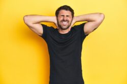 Male adult in black shirt using muscle relaxers wondering if they are addictive