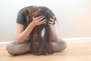 Teen woman sitting with her hair in a mess after green out