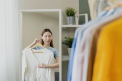 Woman checking clothes for what to wear to drug and alcohol rehab